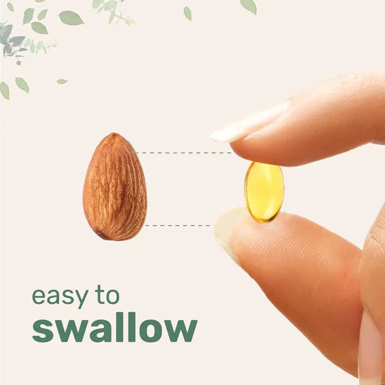 Yellow pill held between fingers next to a almond, with text 'easy to swallow' on a light background.